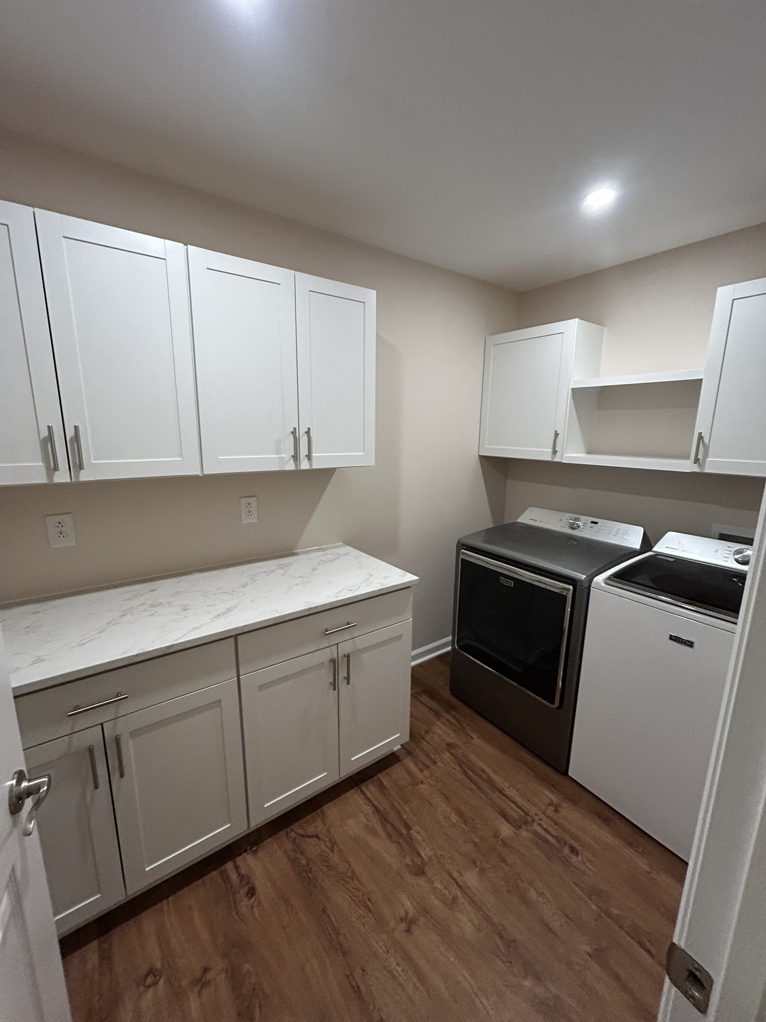 Finished cabinetry, countertop, flooring, and trim completed by MC Home Improvements
